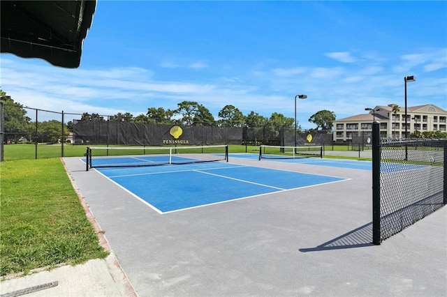 view of tennis court with fence