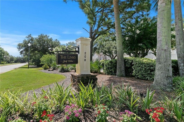 community sign featuring a lawn