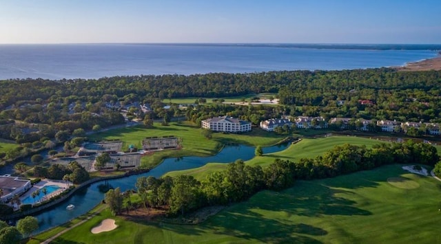 birds eye view of property with view of golf course, a water view, and a forest view