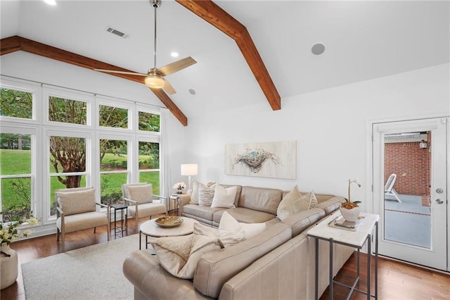 living room featuring ceiling fan, vaulted ceiling with beams, and hardwood / wood-style floors