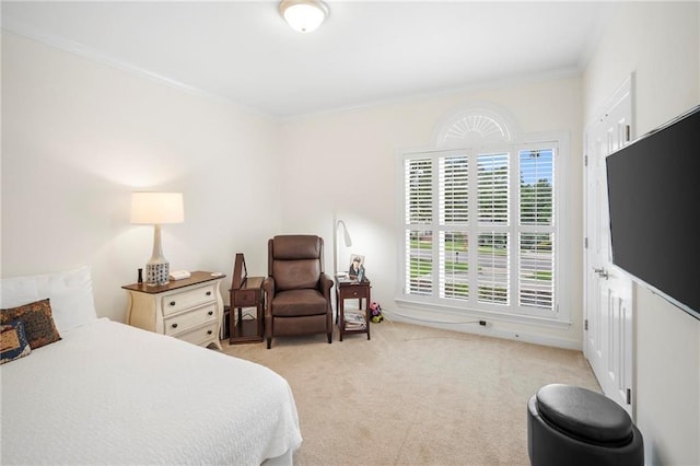 bedroom with ornamental molding and light carpet