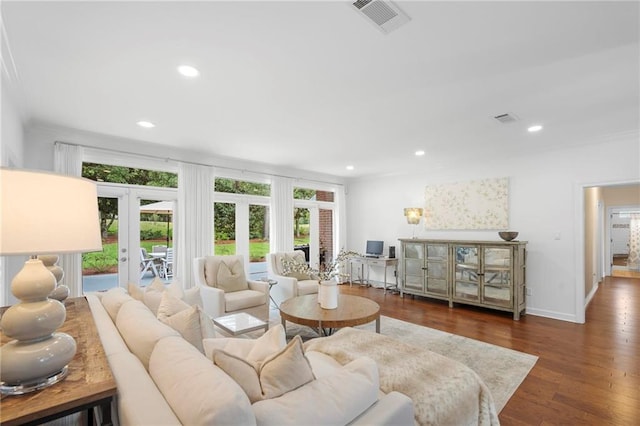 living room featuring dark hardwood / wood-style flooring, crown molding, and french doors