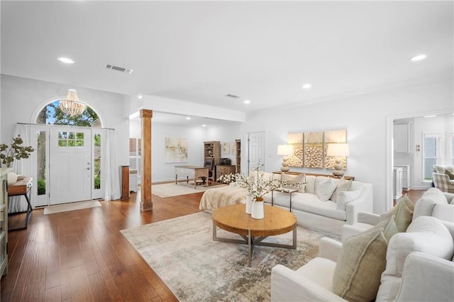 living room featuring hardwood / wood-style flooring and ornate columns