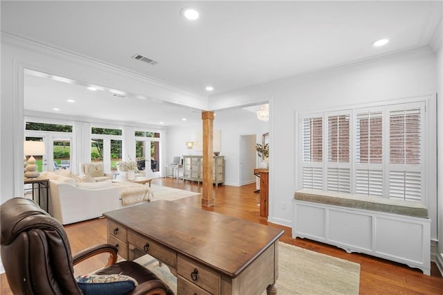 home office featuring crown molding, light hardwood / wood-style flooring, ornate columns, and french doors