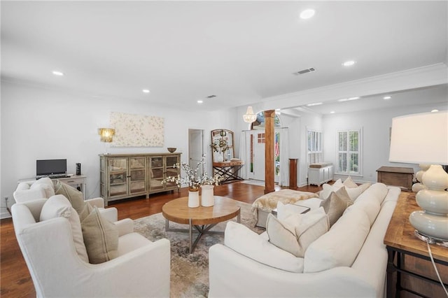 living room featuring dark hardwood / wood-style floors and crown molding