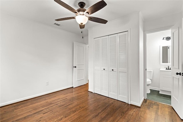 3510 Zimlich Ave, Mobile, AL 36608 - unfurnished bedroom with wood finished floors, a closet, ornamental molding, ceiling fan, and connected bathroom