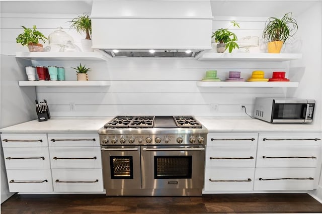 205 George St, Mobile, AL 36604 - kitchen with appliances with stainless steel finishes, open shelves, exhaust hood, and light stone countertops