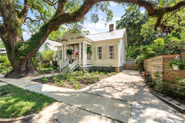 205 George St, Mobile, AL 36604 - view of front of home with a chimney, a porch, and metal roof