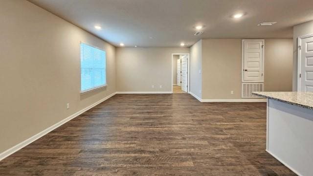 unfurnished living room featuring dark wood-style floors, recessed lighting, visible vents, and baseboards