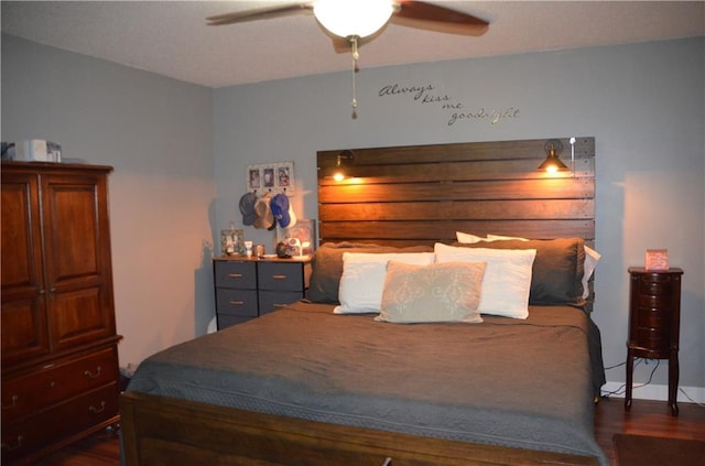 bedroom with a ceiling fan and dark wood-style flooring