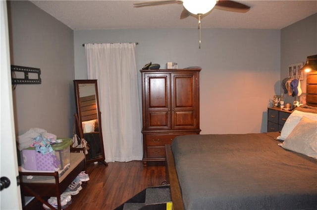 bedroom featuring dark wood-style floors and a ceiling fan