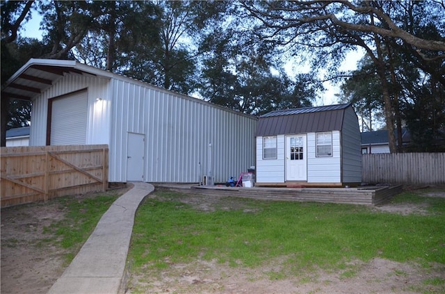 view of outbuilding with an outbuilding and fence