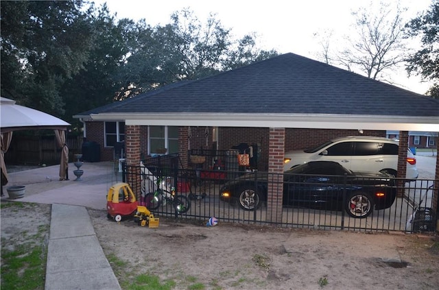 view of front of home featuring roof with shingles and brick siding