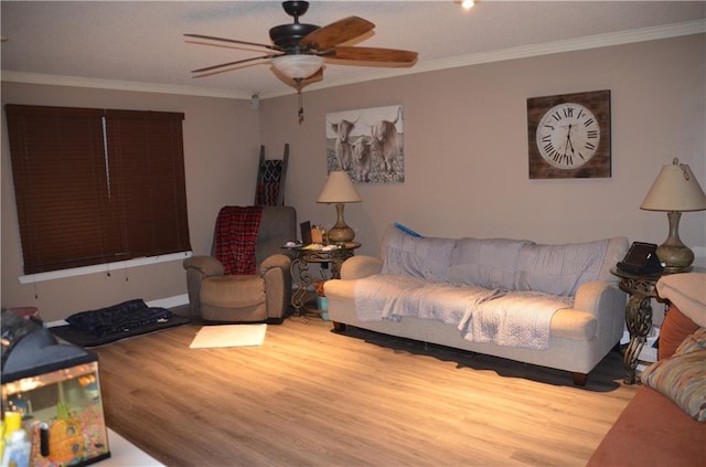 living room with ceiling fan, ornamental molding, and wood finished floors