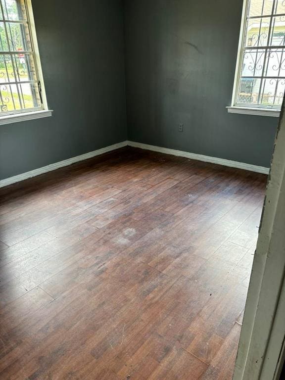 empty room with dark wood-type flooring