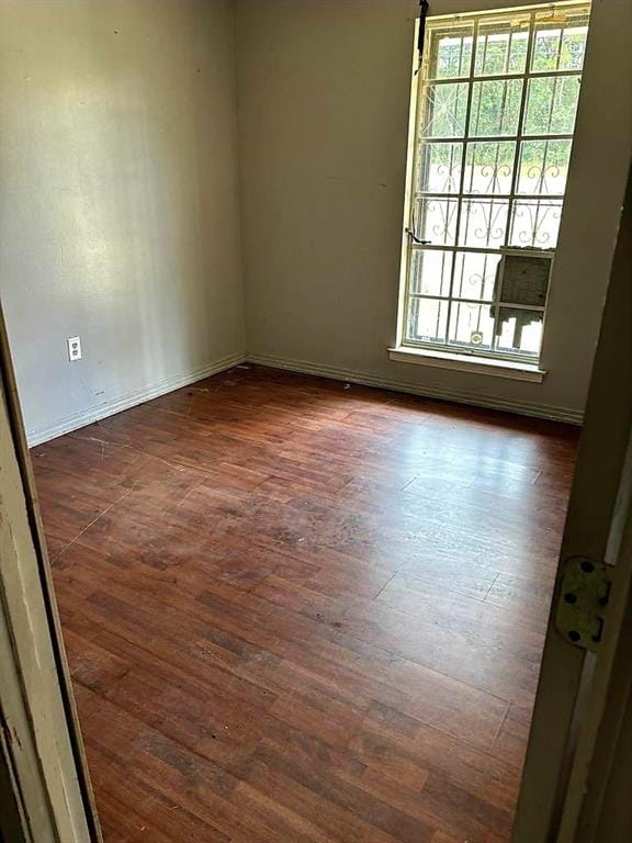 empty room with dark wood-type flooring