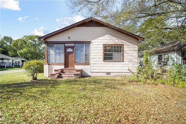 bungalow-style house with a front lawn