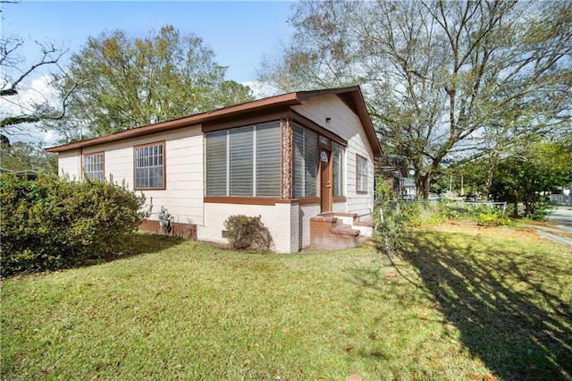 view of home's exterior featuring a yard