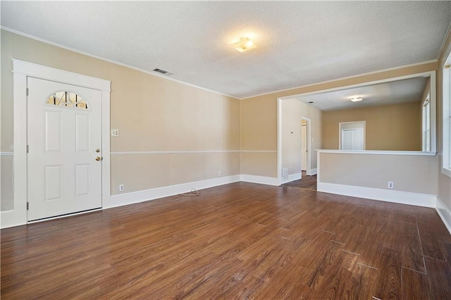 interior space featuring ornamental molding and dark hardwood / wood-style floors