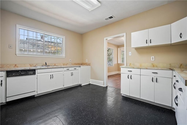 kitchen with white cabinets, dishwasher, and sink