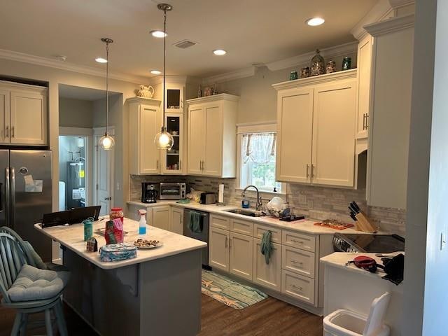 kitchen with decorative light fixtures, tasteful backsplash, dark hardwood / wood-style floors, dishwasher, and sink