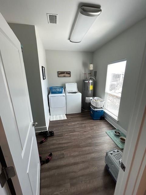 interior space with water heater, separate washer and dryer, and dark wood-type flooring