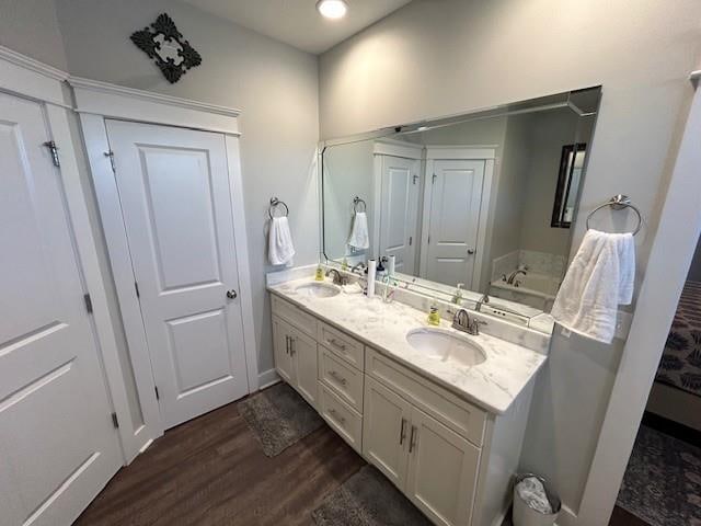 bathroom featuring hardwood / wood-style floors and dual vanity