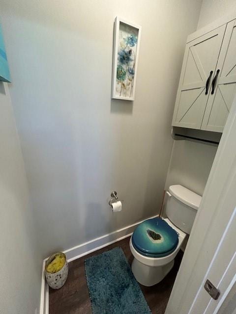 bathroom with hardwood / wood-style floors and toilet