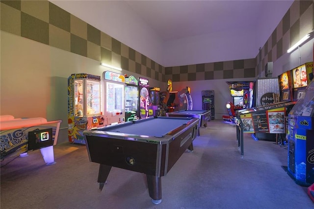 playroom with a high ceiling, pool table, and light colored carpet