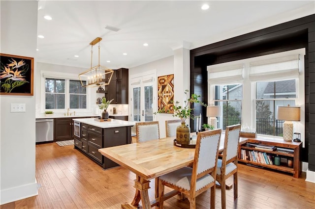 dining room with recessed lighting, plenty of natural light, and light wood finished floors