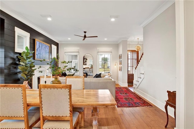 dining room with recessed lighting, stairway, ornamental molding, wood finished floors, and baseboards