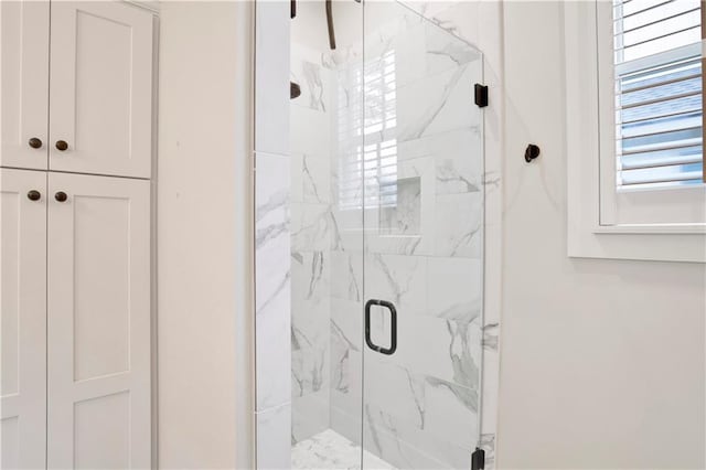 full bathroom with a marble finish shower