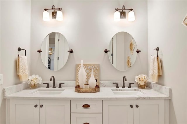 bathroom featuring a sink and double vanity