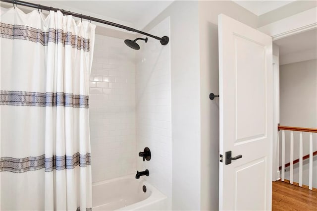 bathroom with shower / tub combo with curtain and wood finished floors