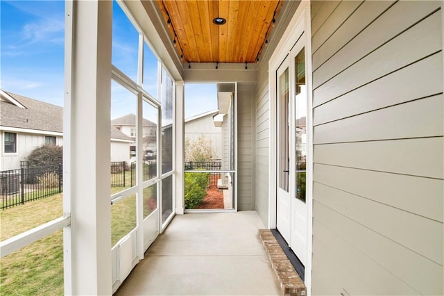 unfurnished sunroom featuring wooden ceiling