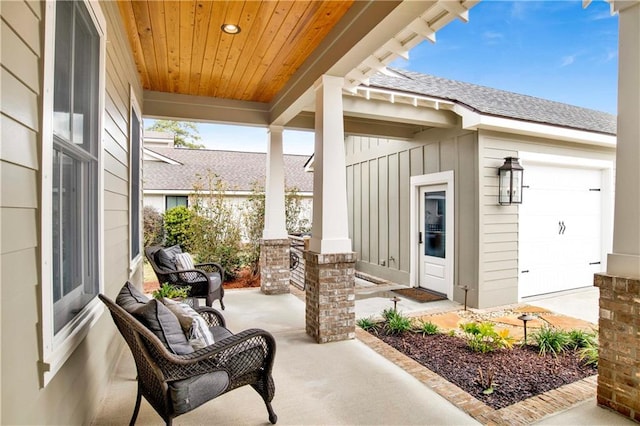 view of patio / terrace with an attached garage and covered porch