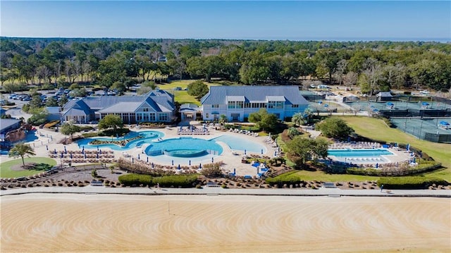 bird's eye view with a wooded view