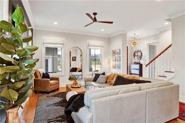 living area featuring ornamental molding, wood finished floors, a ceiling fan, and recessed lighting