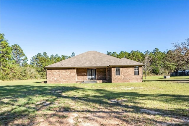 rear view of house with a lawn