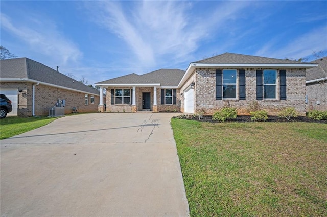 view of front of home featuring central AC unit, driveway, a front lawn, a garage, and brick siding