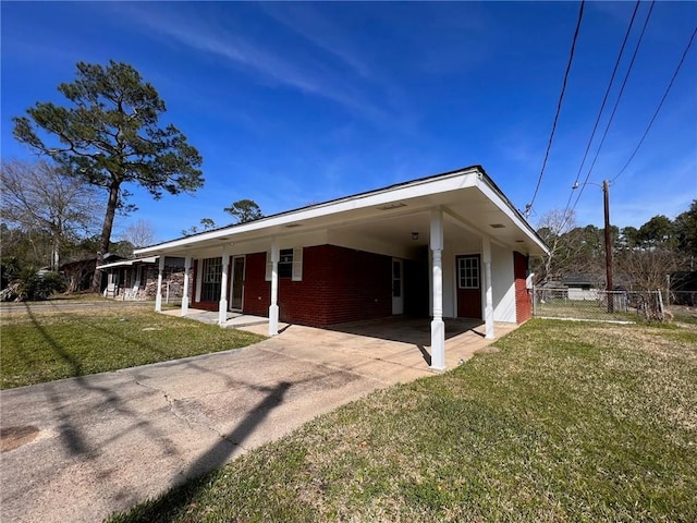 3716 Anita Dr, Gulfport, MS 39501 - rear view of house featuring concrete driveway, a carport, and brick siding