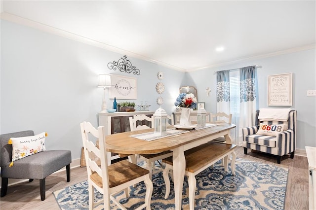 dining area featuring crown molding and hardwood / wood-style flooring