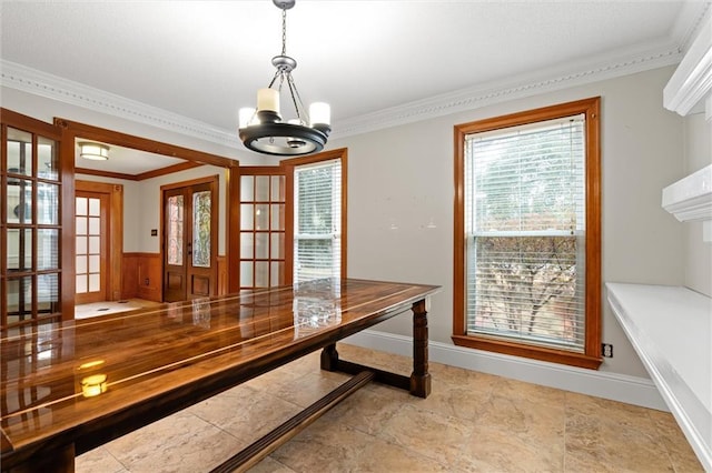 unfurnished dining area featuring an inviting chandelier and ornamental molding