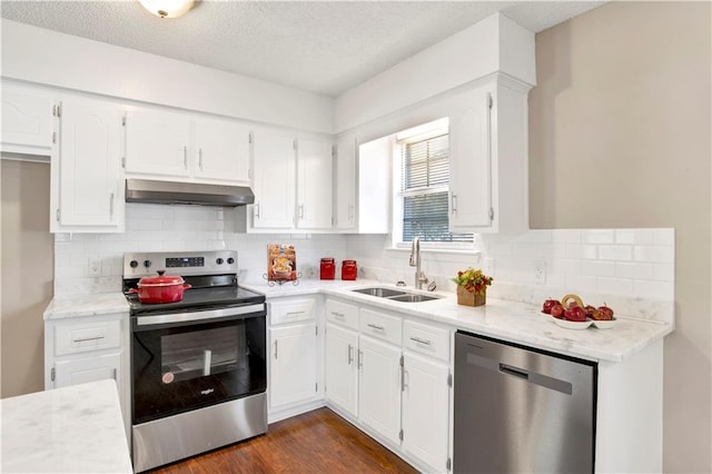 kitchen with sink, white cabinetry, stainless steel appliances, dark hardwood / wood-style flooring, and decorative backsplash