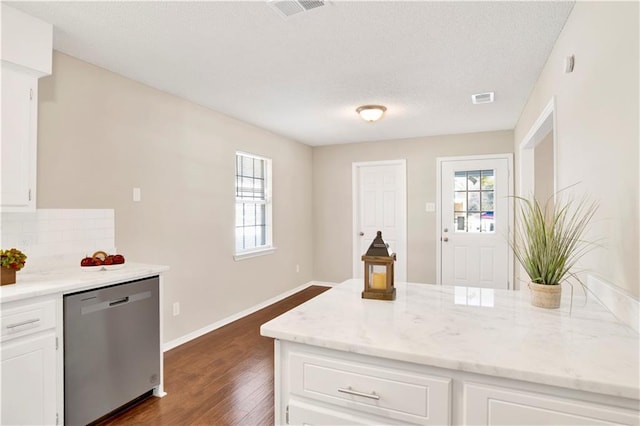 kitchen featuring white cabinetry, backsplash, light stone countertops, dark hardwood / wood-style flooring, and stainless steel dishwasher