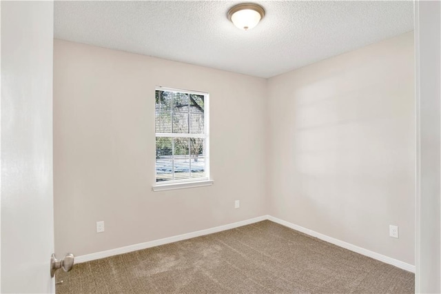 carpeted spare room featuring a textured ceiling