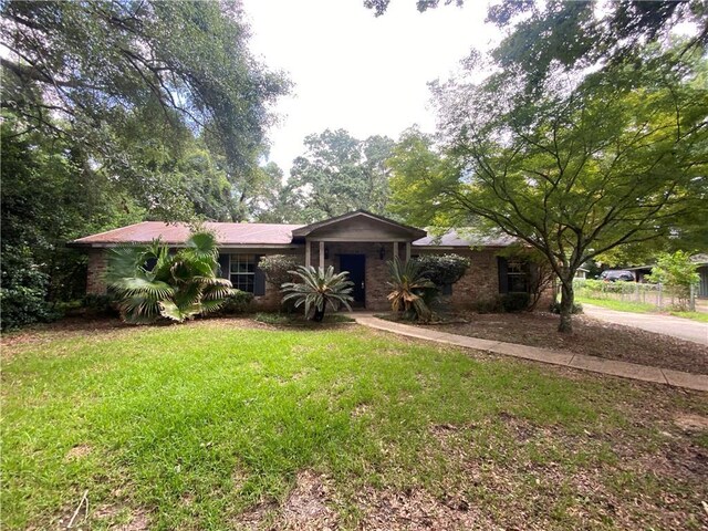 ranch-style home with a front lawn