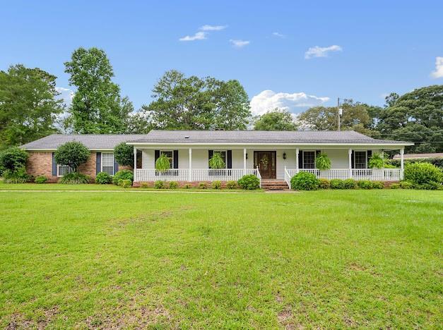 4501 Harvest Blvd E, Semmes, AL 36575 - ranch-style home with covered porch and a front lawn
