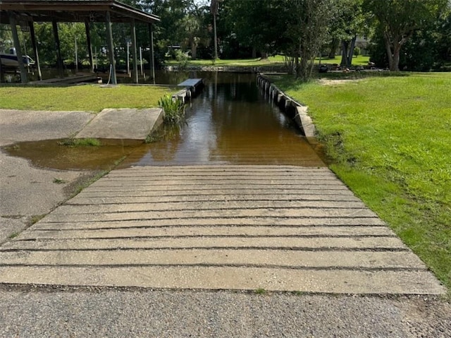 5541 Riverwood Lndg, Theodore, AL 36582 - dock area with a boat ramp, a yard, and a water view