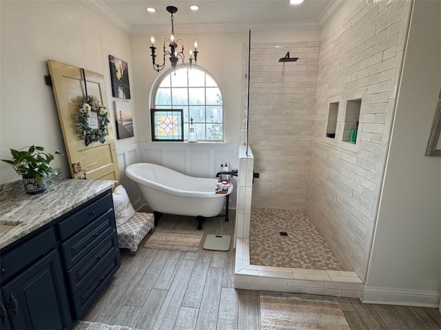 5541 Riverwood Lndg, Theodore, AL 36582 - full bathroom with wood finished floors, a tile shower, a freestanding tub, a chandelier, and vanity